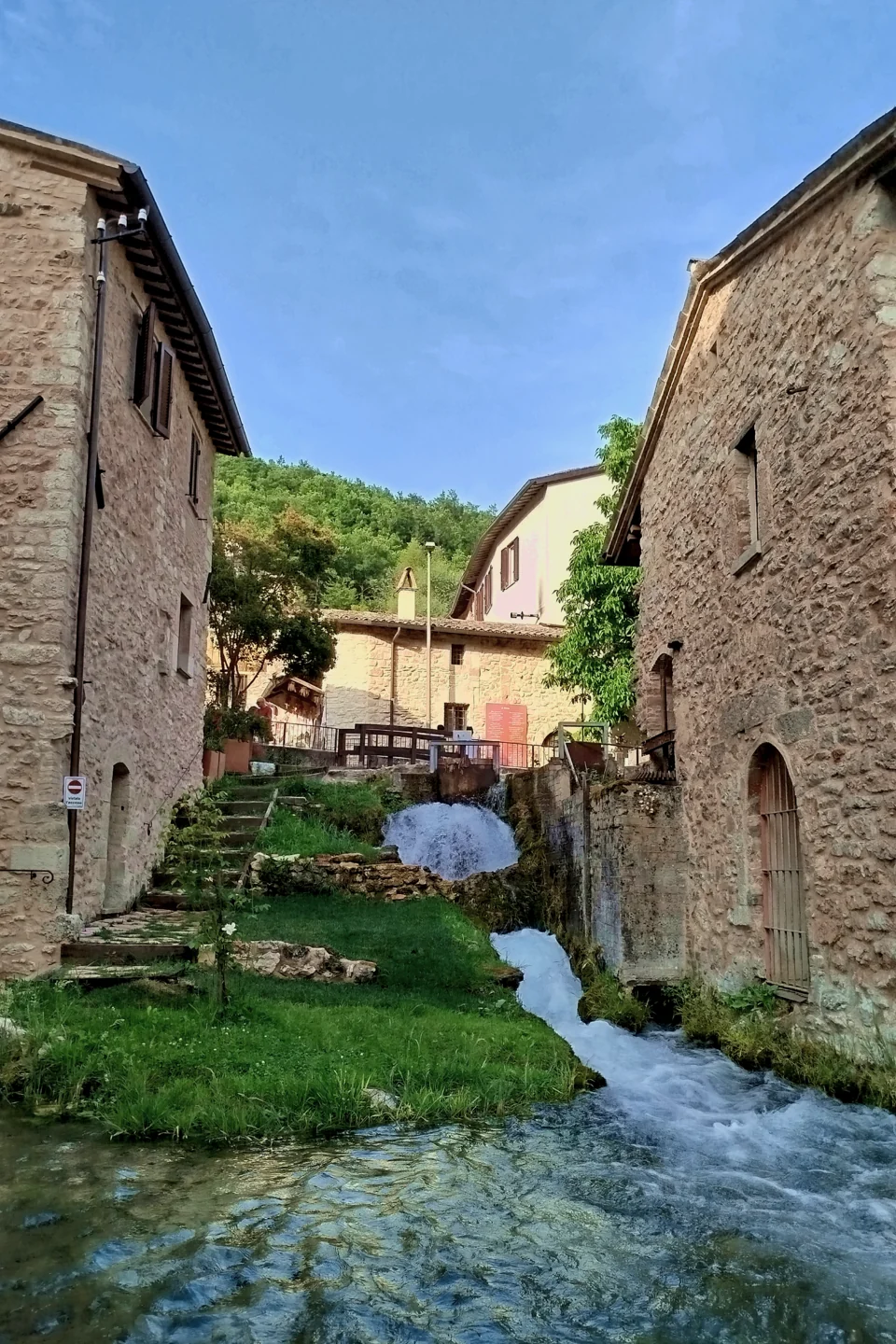 Clear water and small waterfalls between stone houses in Rasiglia, Umbria