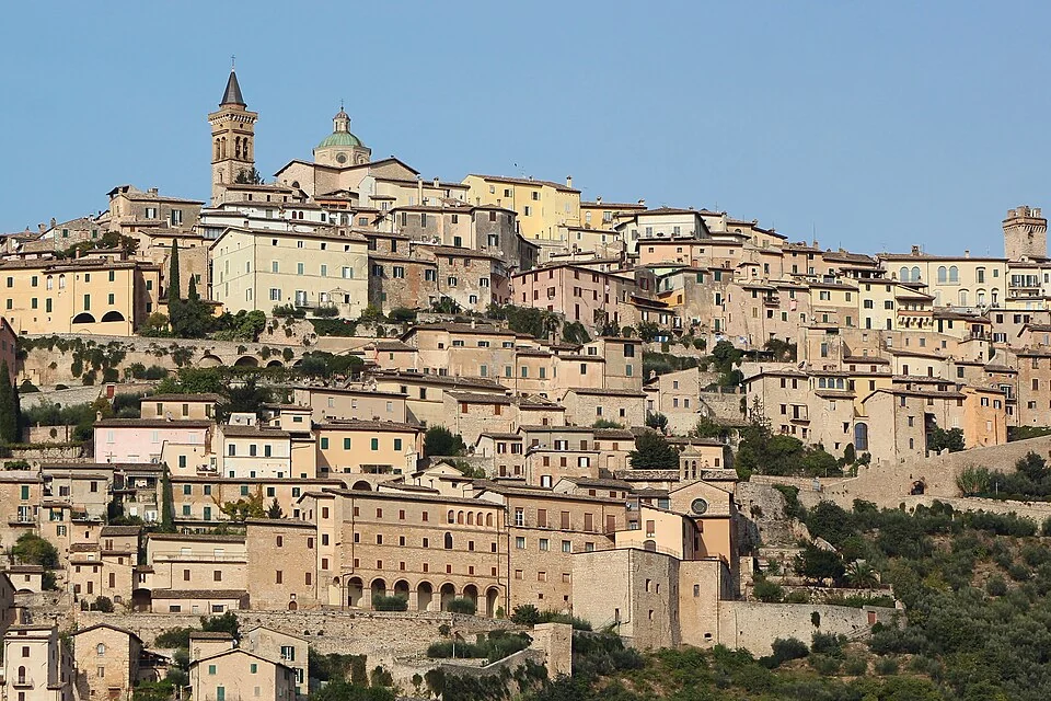 Sunlit stone buildings and the bell tower of Trevi, Umbria