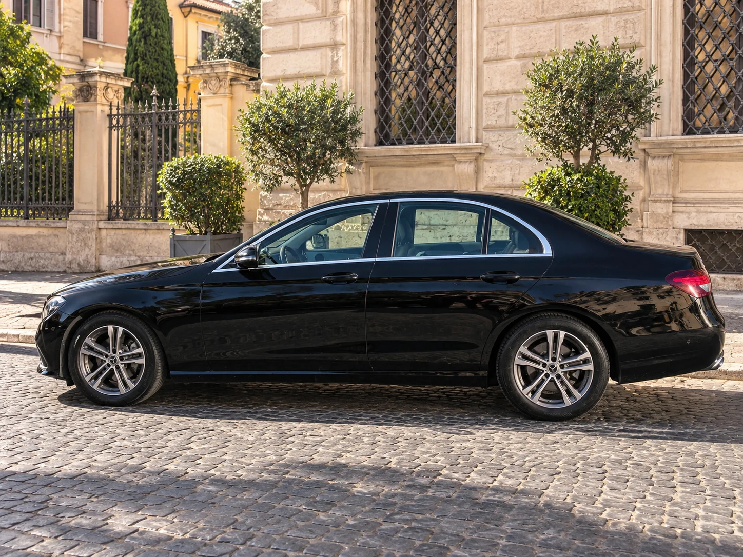 Black Mercedes-Benz E-Class prepared for a private chauffeur service in Rome